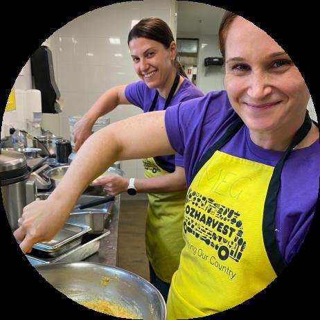 Two ANZ employees prepare meals for a local charity