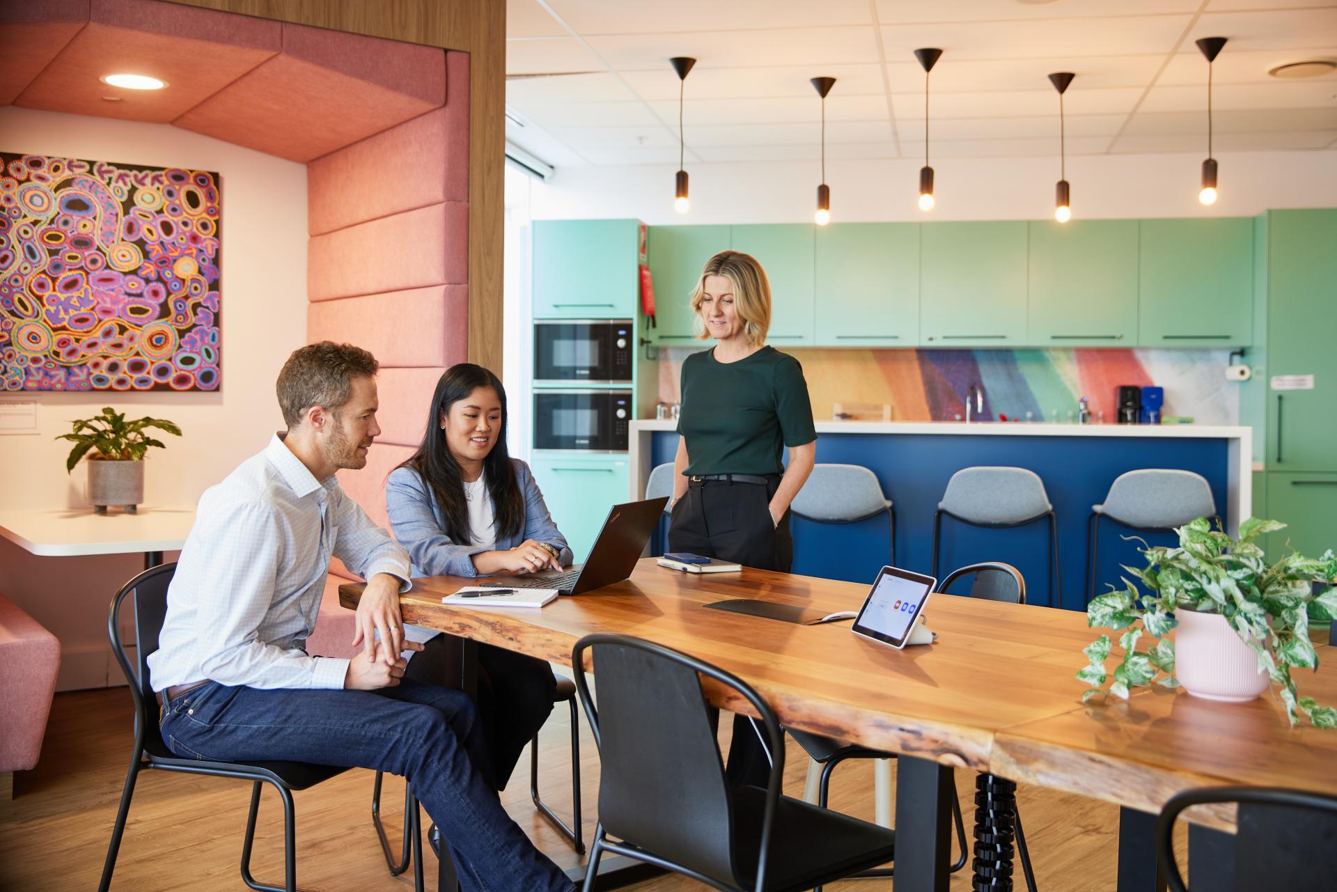 Three employees working together in the Vertex Sydney office