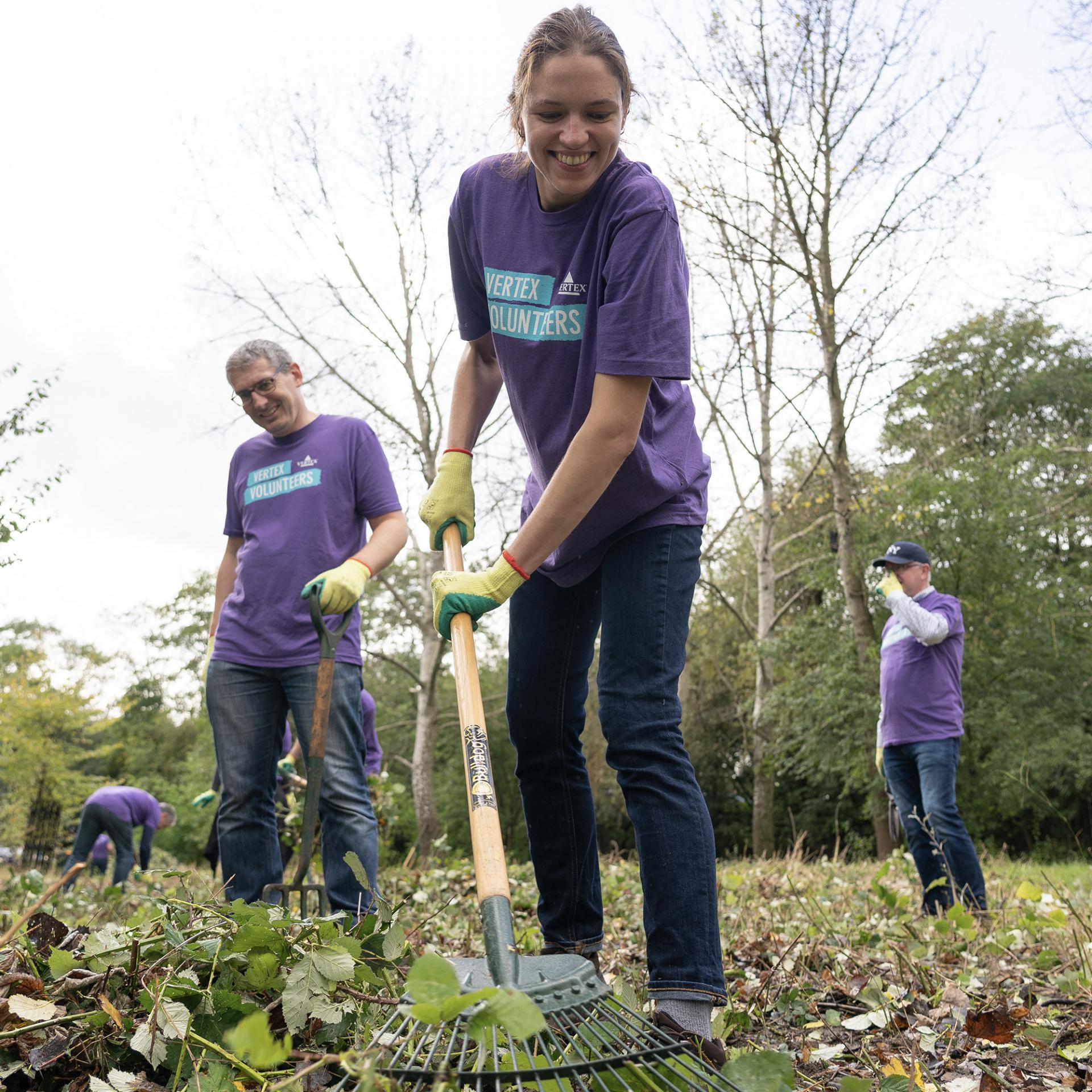 Vertex employee at Day of Service event volunteering time raking