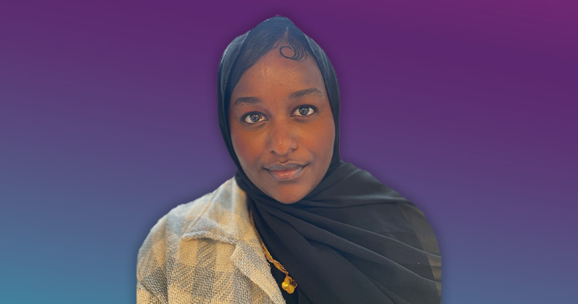 An image with a purple background of Sumeya Aweys smiling.